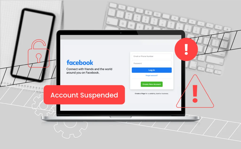 A laptop screen displaying a locked Facebook login page with a red warning triangle and the word 'Account Suspended' when you are banned from Facebook. The surrounding workspace includes a phone and notepad.